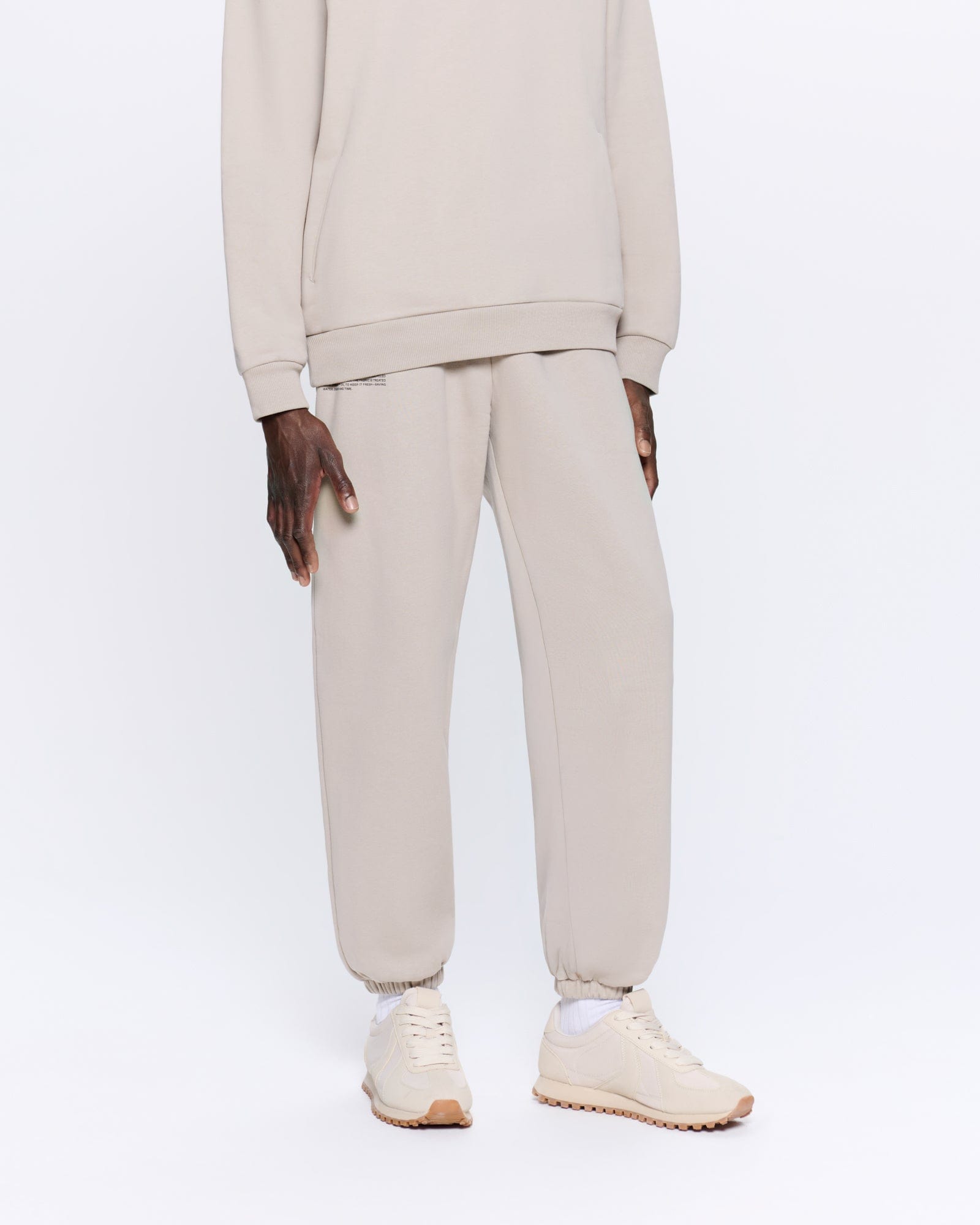 365_HEAVYWEIGHT_TRACK_PANTS_STONE_MENS_FRONT-MODEL