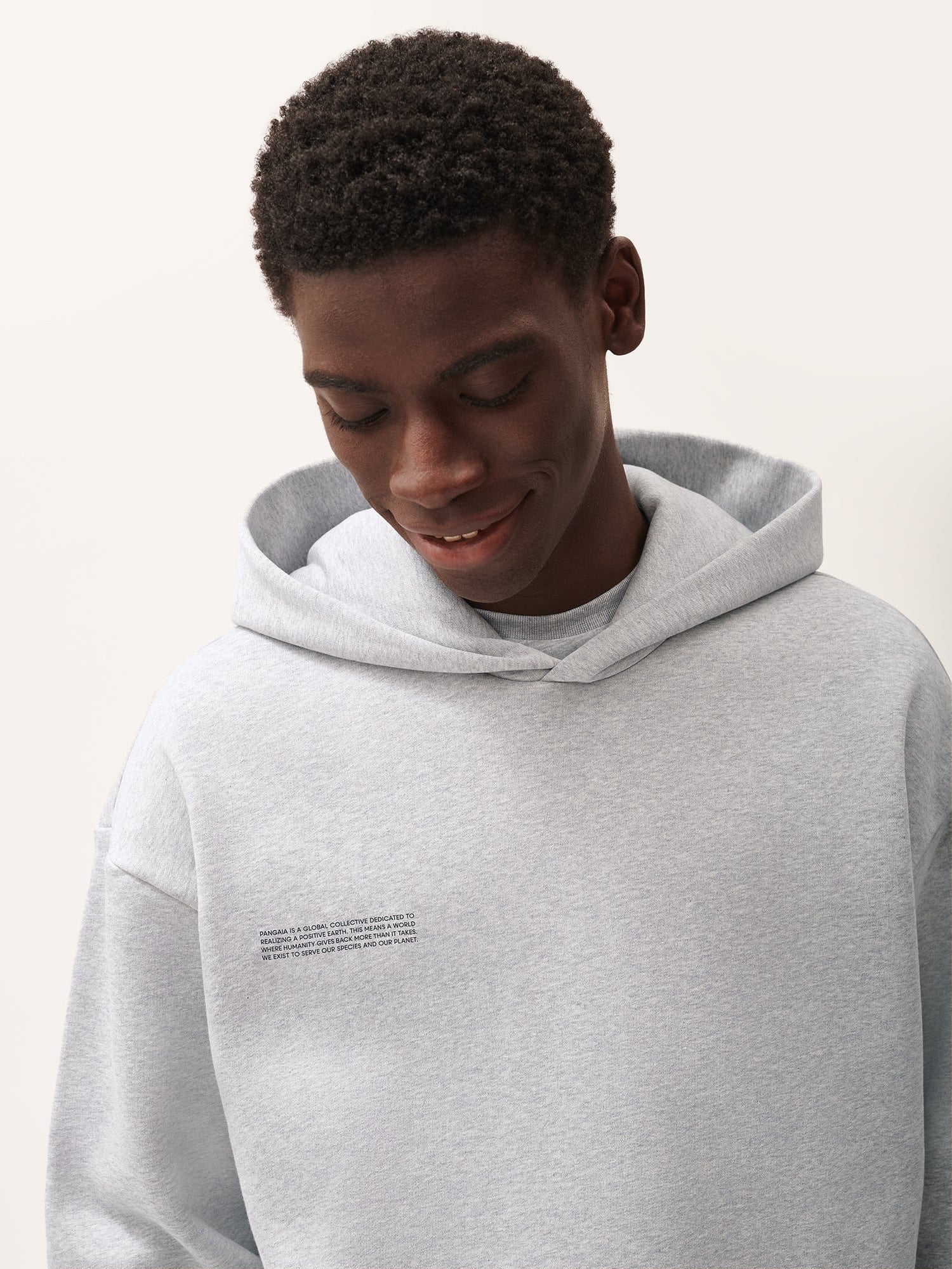 Heather grey men's oversized cotton fleece hoodie. Premium hooded sweatshirt with subtle brand text print