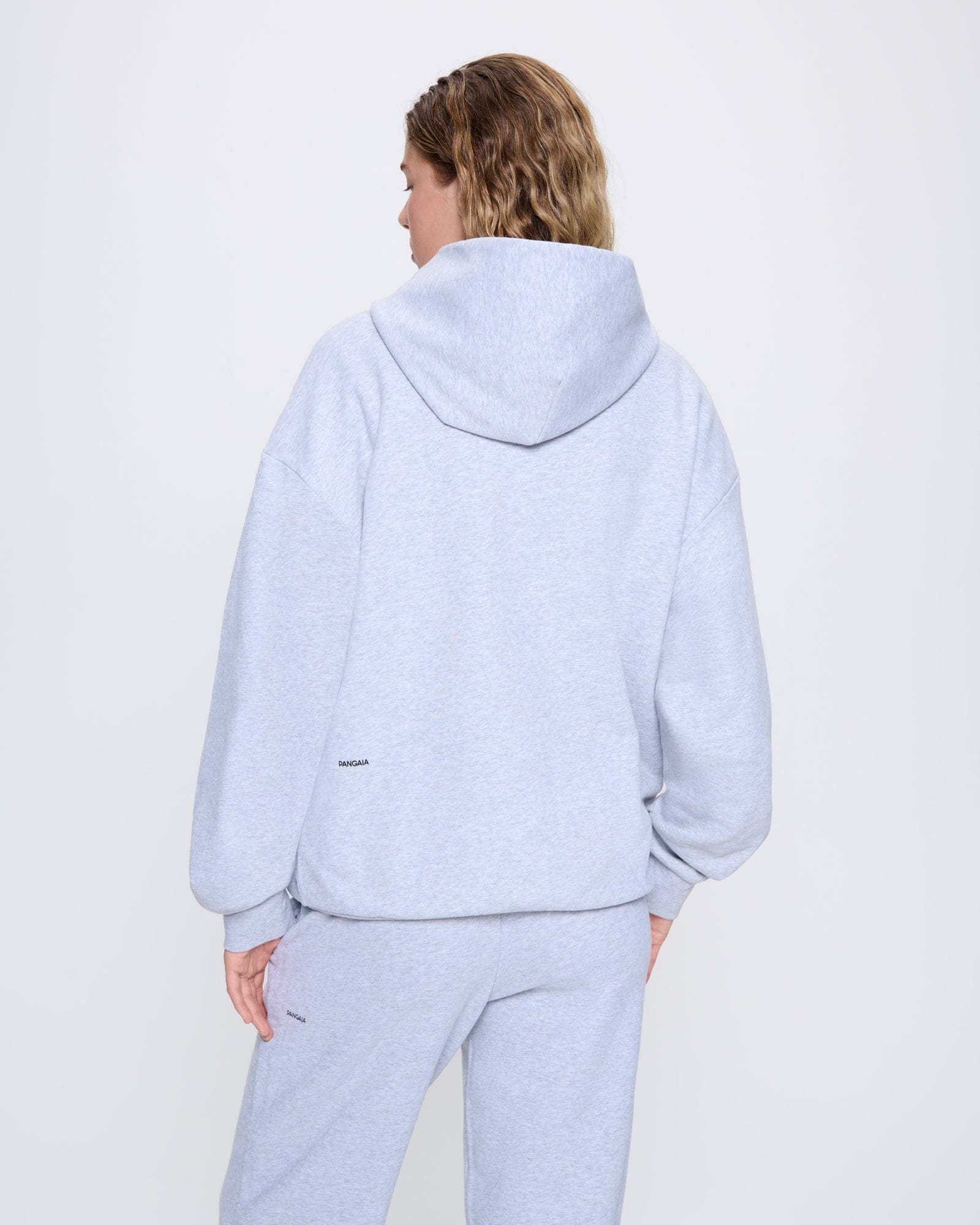365_MIDWEIGHT_HOODIE_GREY-MARL_WOMENS_BACK-MODEL