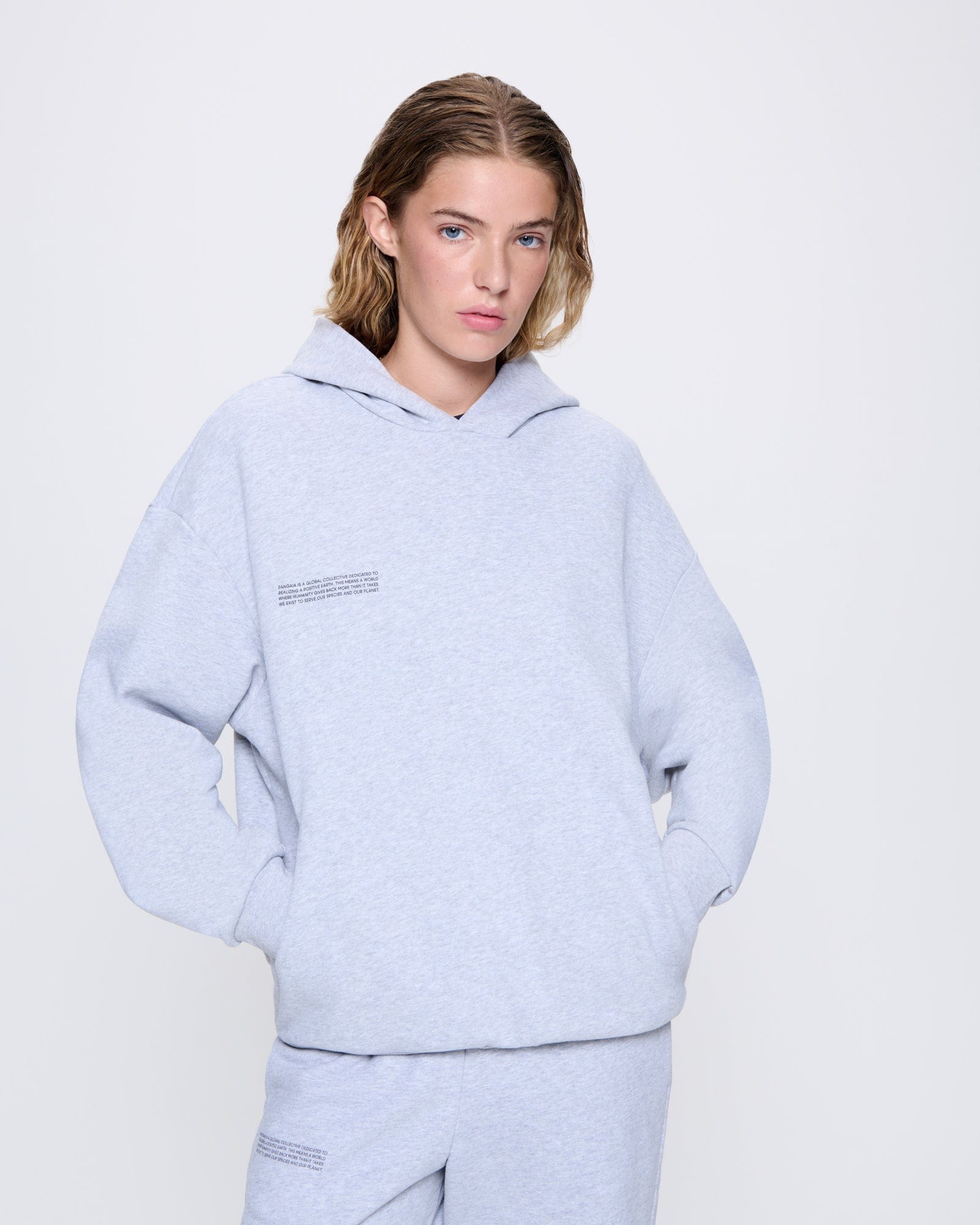 365_MIDWEIGHT_HOODIE_GREY-MARL_WOMENS_FRONT-MODEL