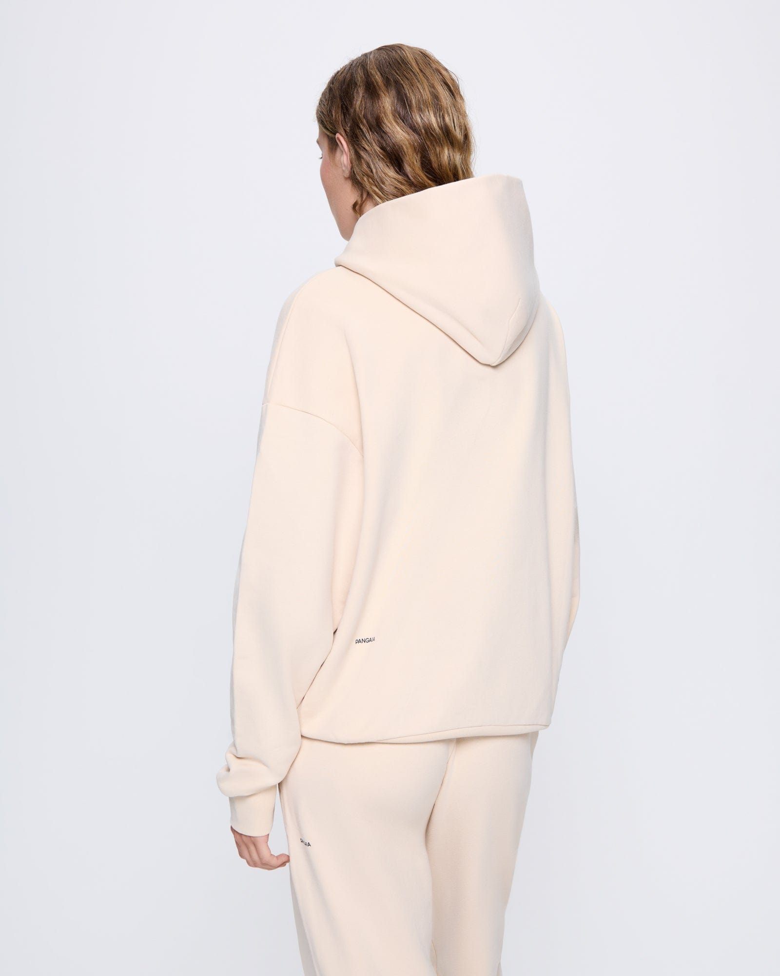 365_MIDWEIGHT_HOODIE_SAND_WOMENS_BACK-MODEL