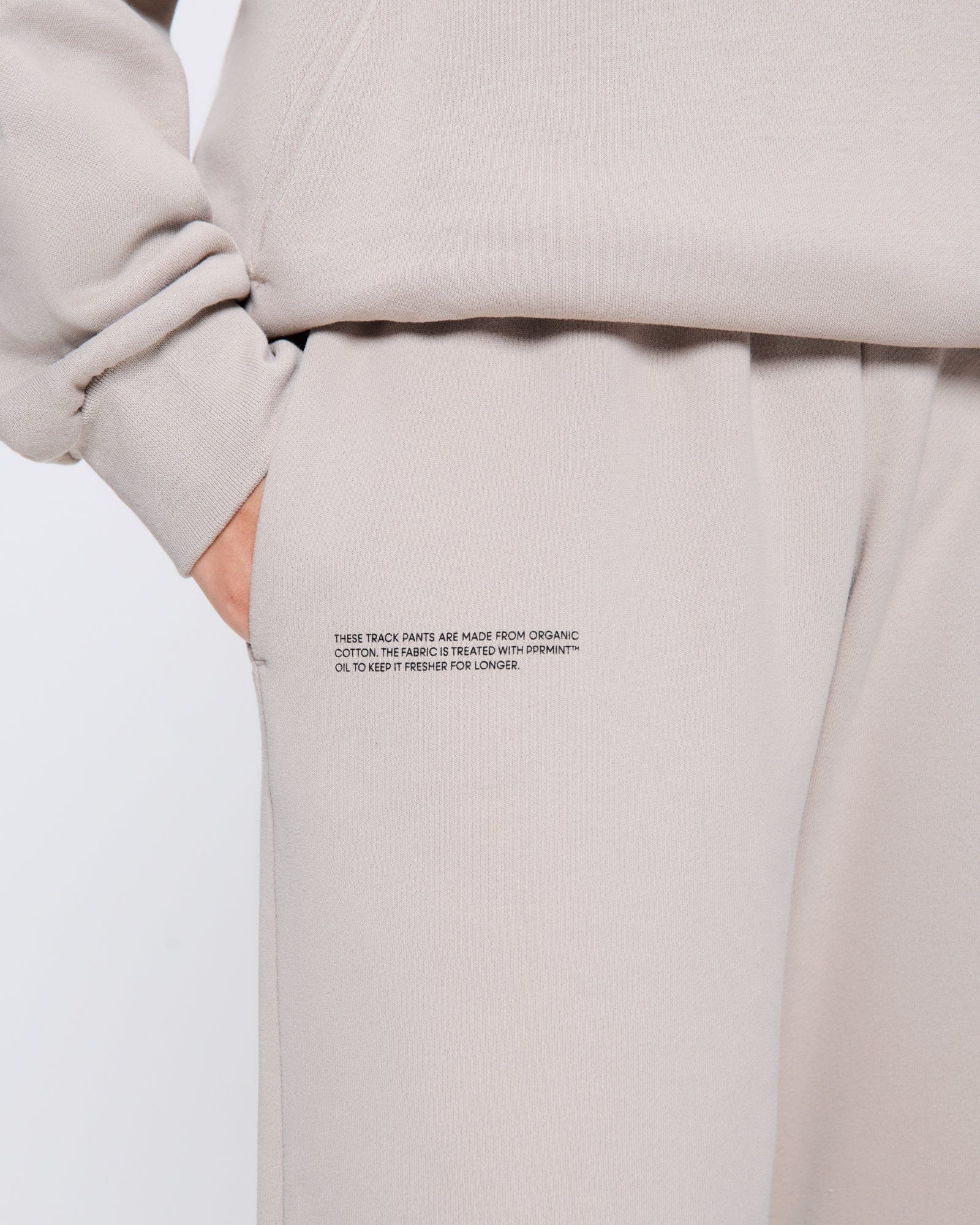 365_MIDWEIGHT_TRACKPANTS_STONE_WOMENS_DETAIL_ba2936c8-46e7-4d74-bde7-5a62bb167b74-MODEL