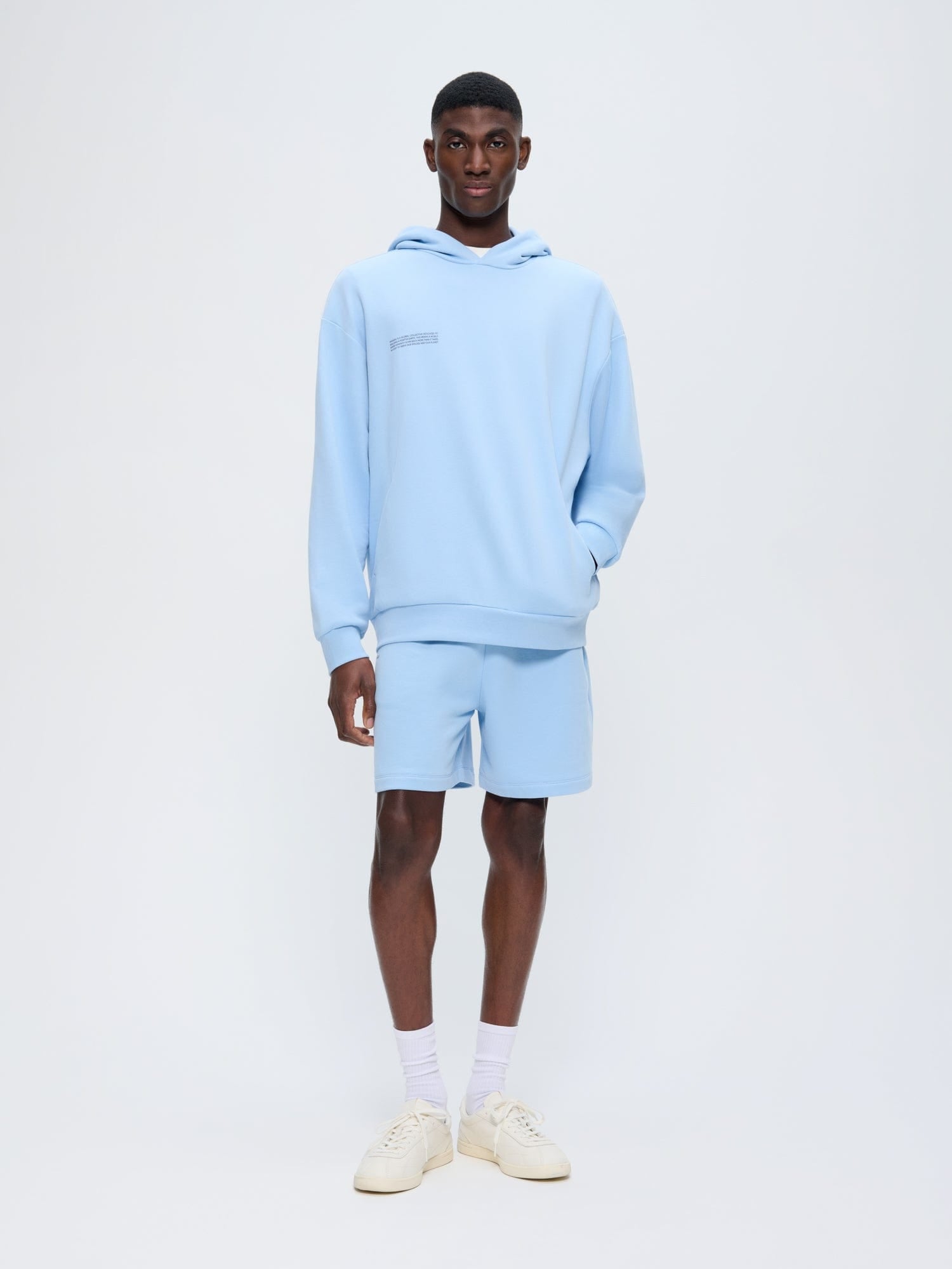 Men's light blue oversized hooded sweatshirt and matching sweat shorts set. Relaxed fit loungewear