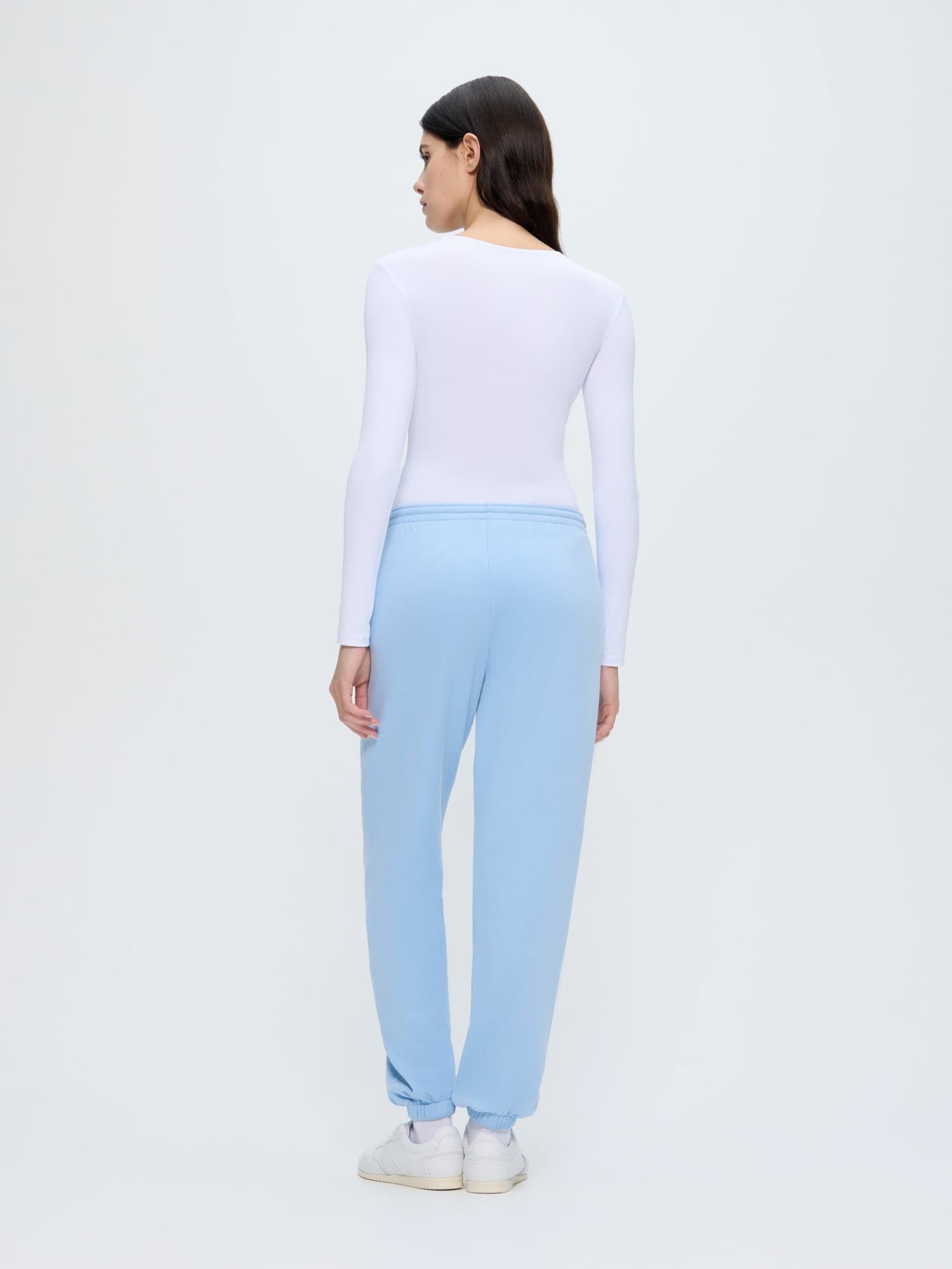 Womens 365 Midweight Dewdrop Blue organic cotton track pants, loose oversized fit, model back view, lightweight breathable