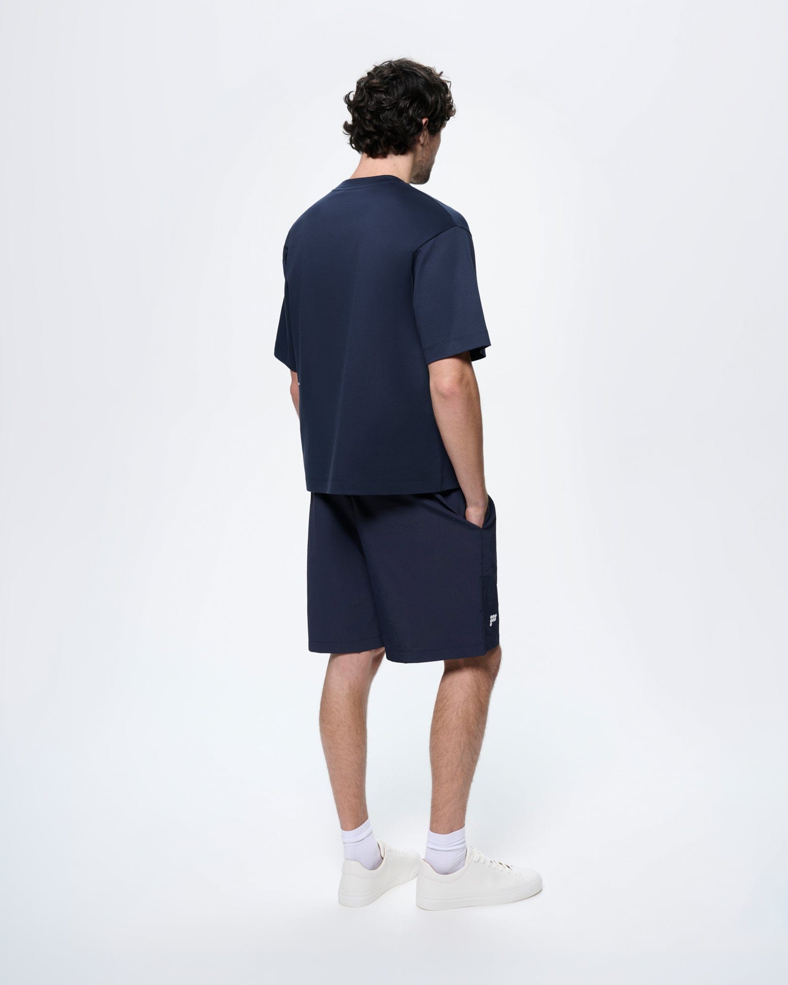 Mens Granite Navy Interlock Oversized T-Shirt. Man from back wearing relaxed fit organic cotton crew neck