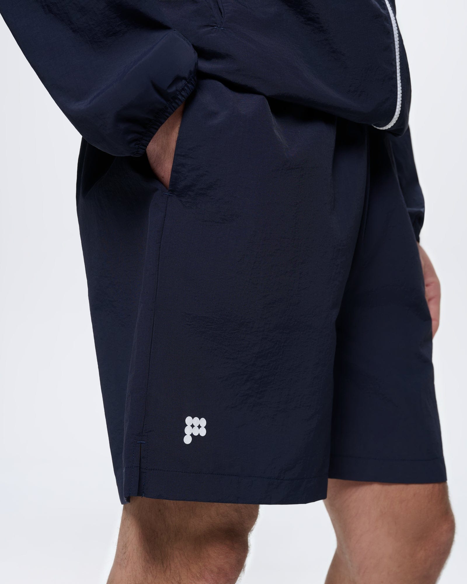 Mens Granite Navy Recycled Nylon Shorts. Mid-length, regular fit with lightweight 100% recycled polyamide fabric & white logo