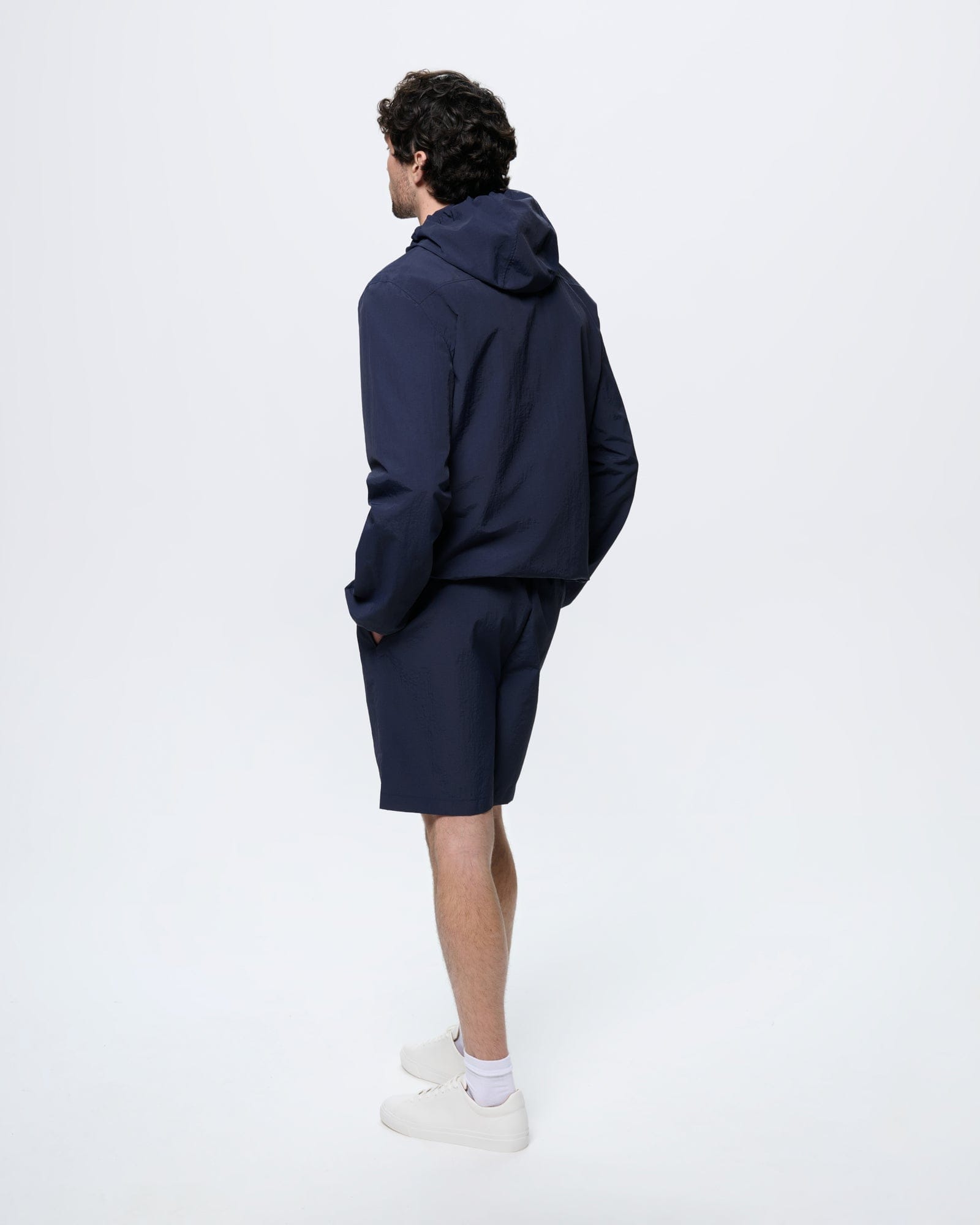 Mens Recycled Nylon Shorts Granite Navy, mid-length regular fit, 100% recycled polyamide. Man in back view