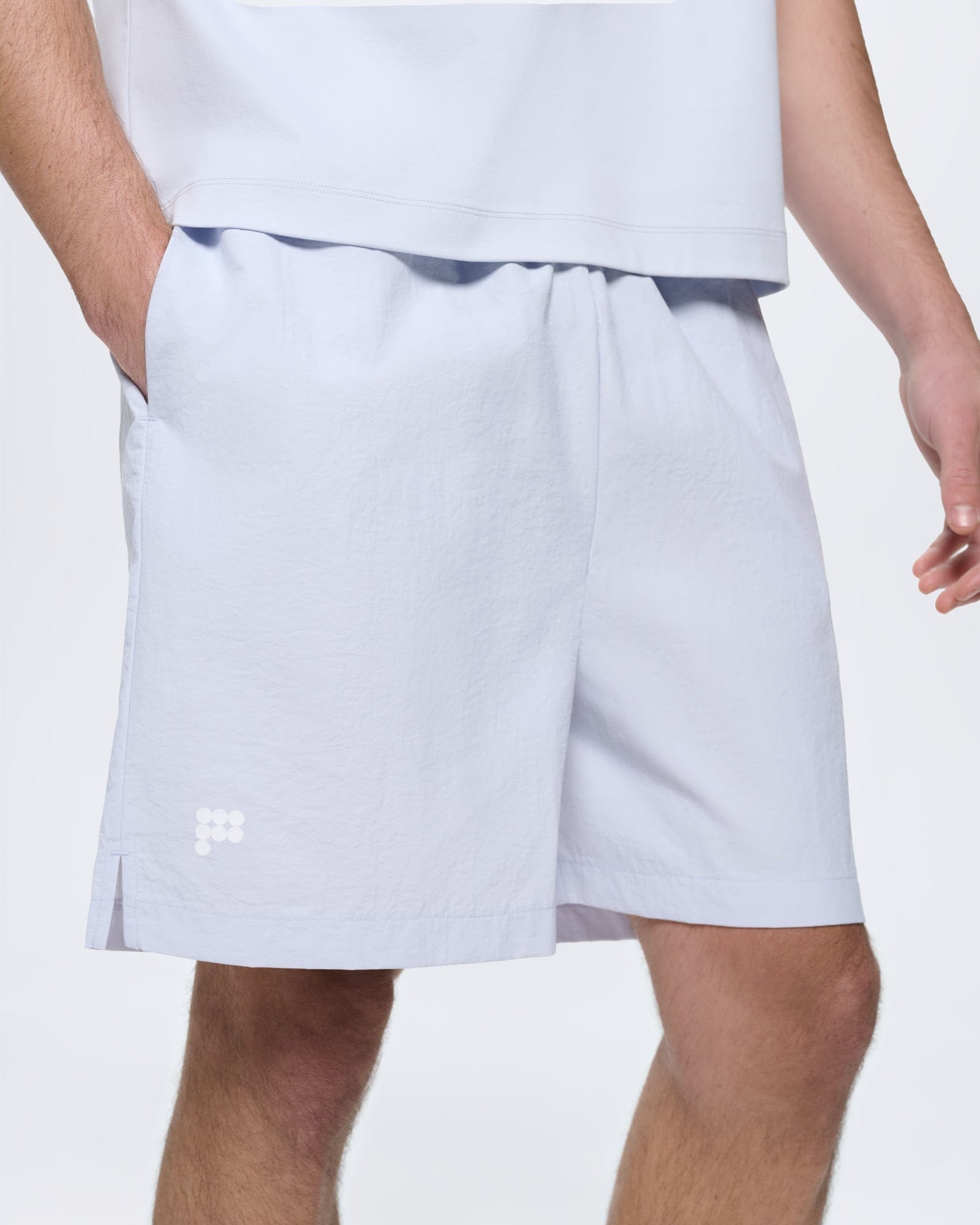 Mens Ice Grey Recycled Nylon Shorts. Mid-length, regular fit on model. Lightweight textured polyamide fabric, side slit, logo