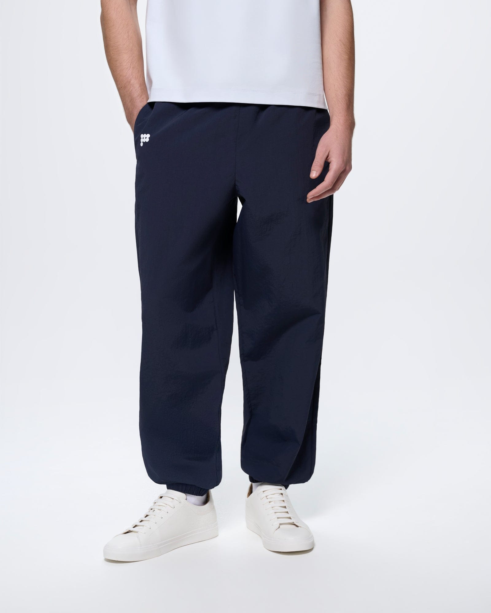 Men's Granite Navy recycled polyamide track pants, oversized fit, lightweight with crinkled texture and elasticated cuffs