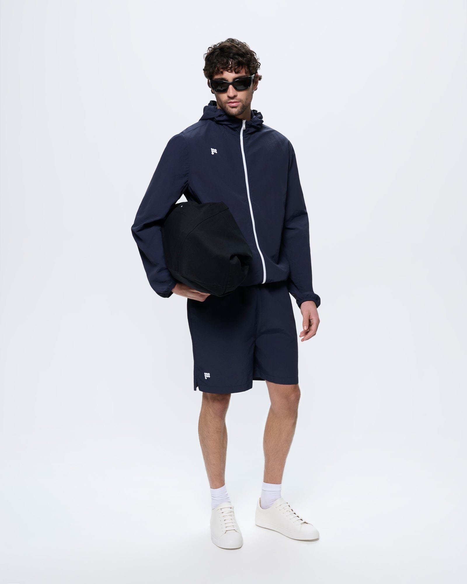 Mens Granite Navy Recycled Nylon Zip Up Hooded Jacket with white zipper, lightweight, regular fit, on model