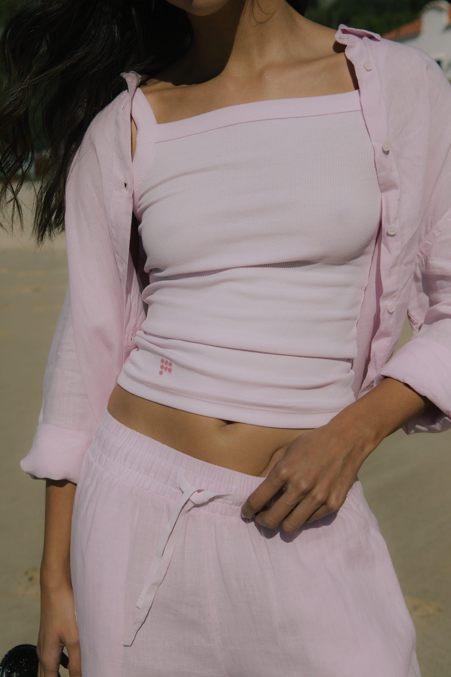 Blush pink ribbed knit square-neck tank top, oversized linen button-up shirt, and loose drawstring linen pants