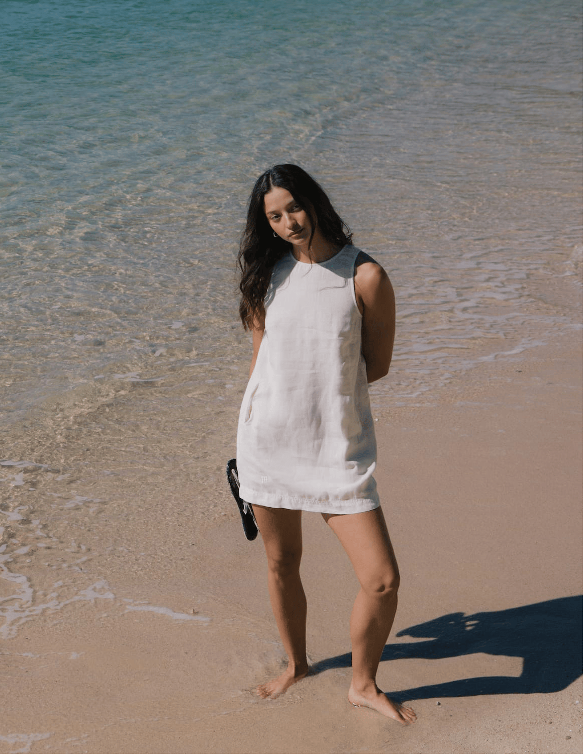 Cream linen sleeveless mini dress. Relaxed fit, round neck, side pockets. Summer resort beach style