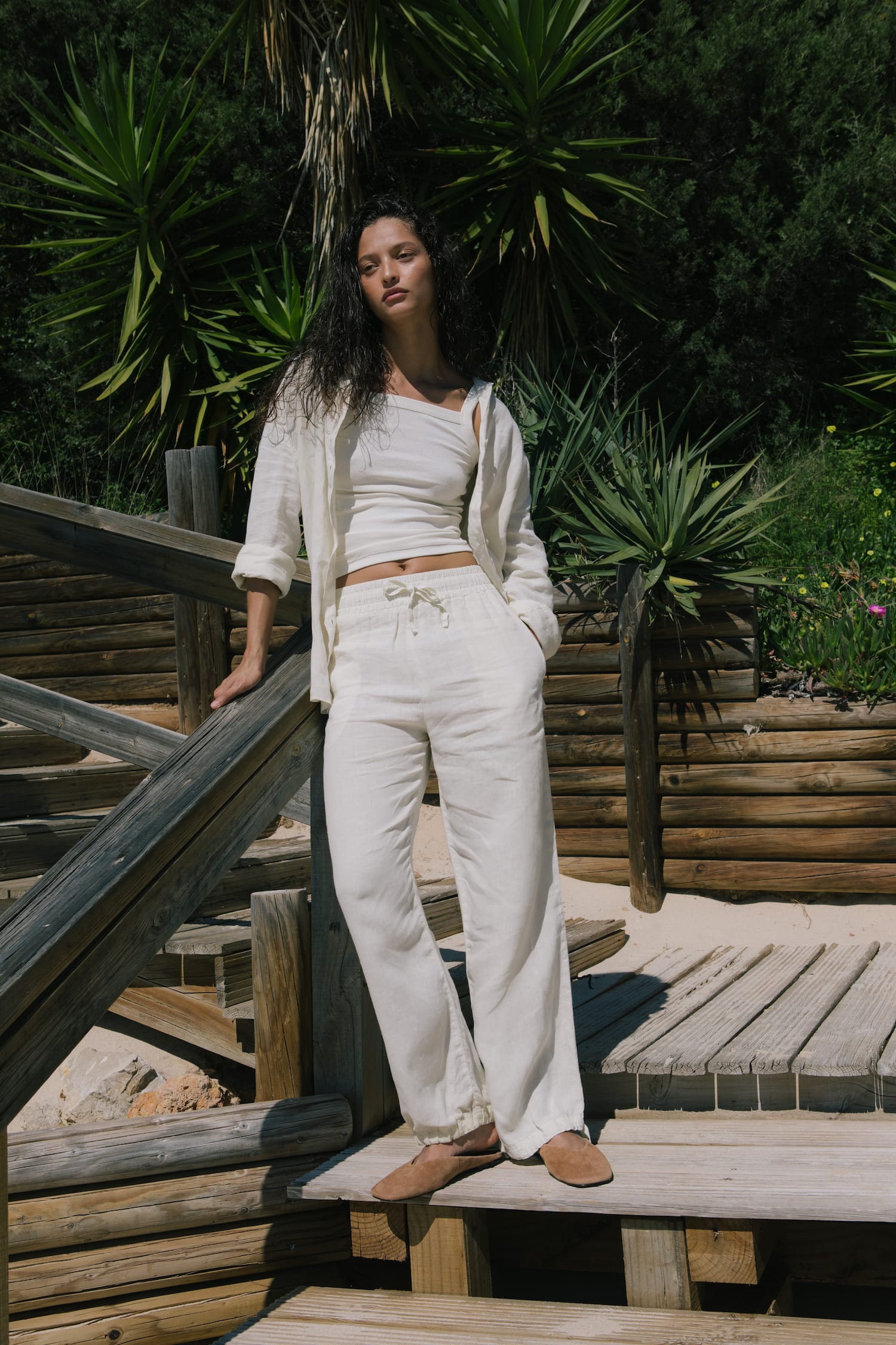 Women's ecru linen oversized shirt, ribbed crop top, wide-leg drawstring pants outfit. Premium resort wear