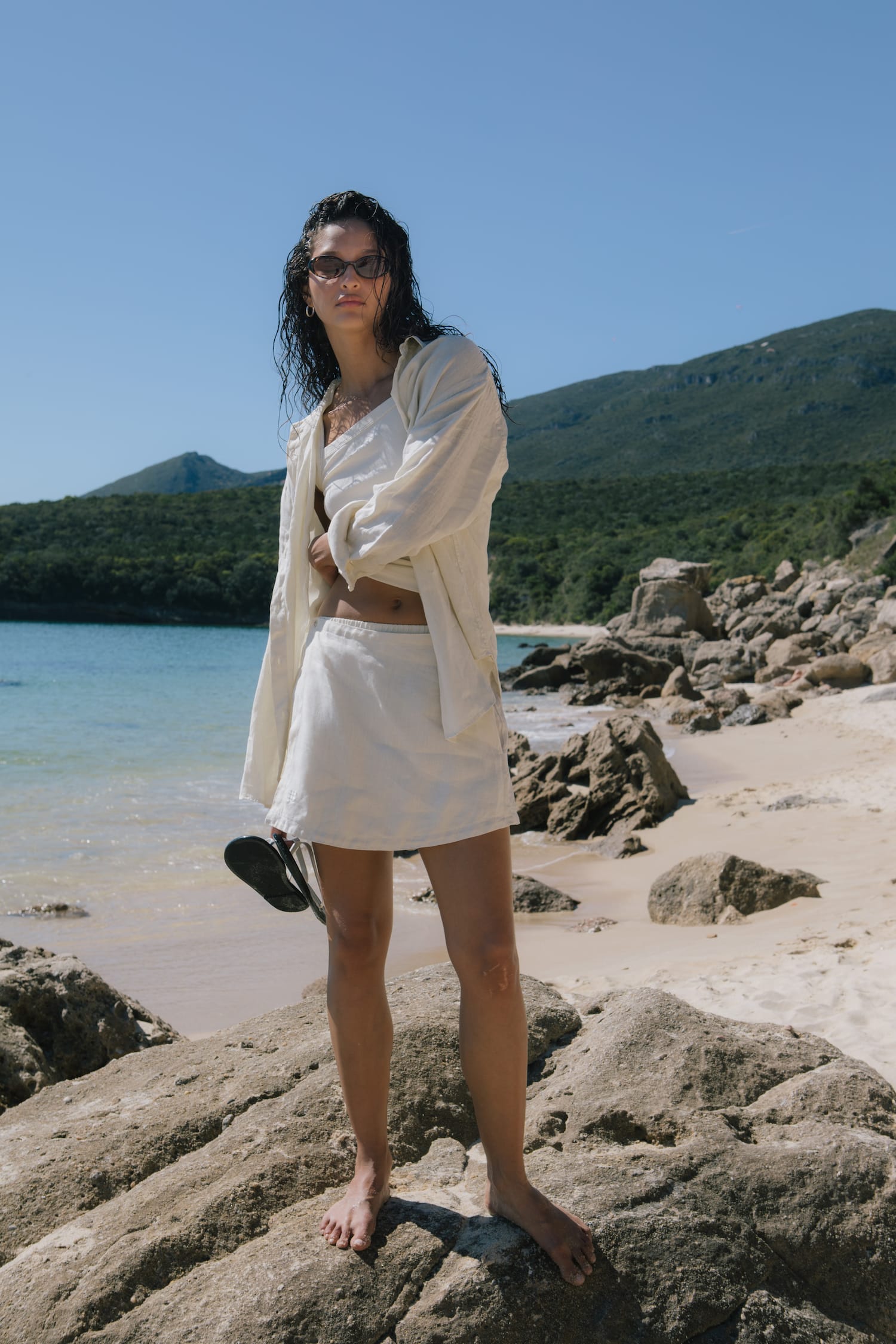 Cream linen co-ord set: oversized long-sleeve shirt, bralette crop top, and elastic waist mini skirt on model.