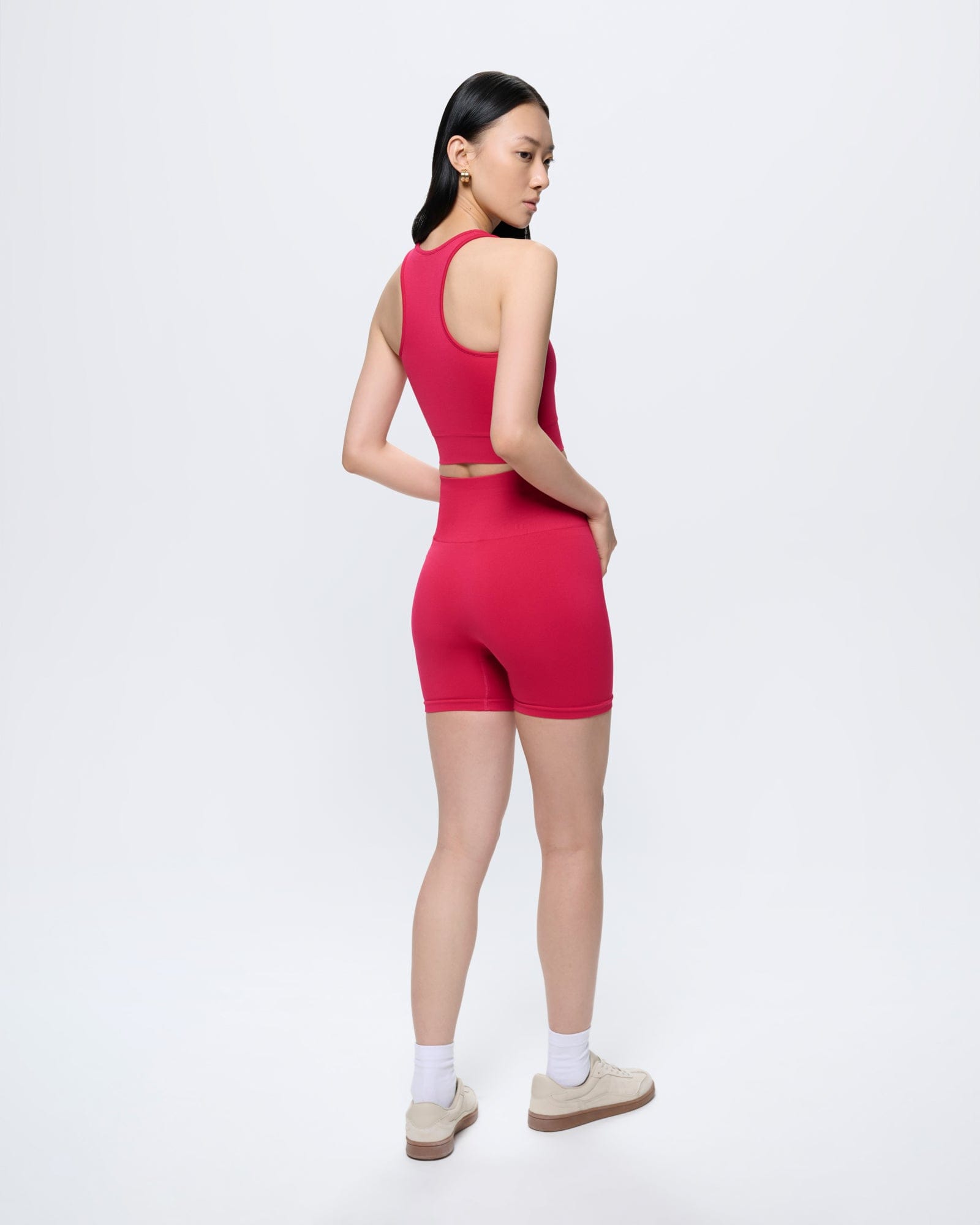 Womens Açai Pink 99% Bio-Based Compressive Shorts & matching crop top. Model viewed from behind, ultra-close fit