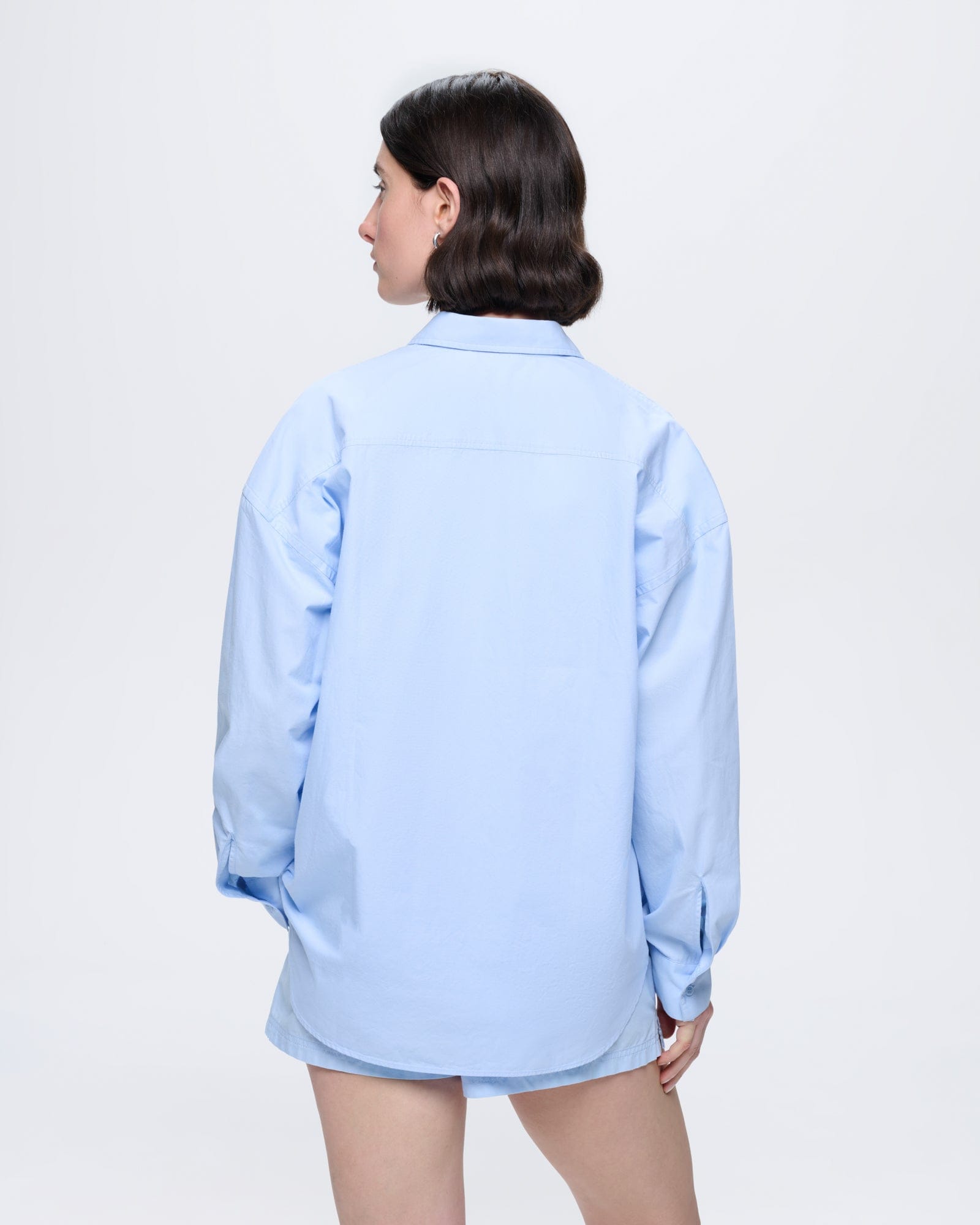 Womens Wildflower Blue organic cotton poplin oversized overshirt, back view on model, long sleeves, lightweight