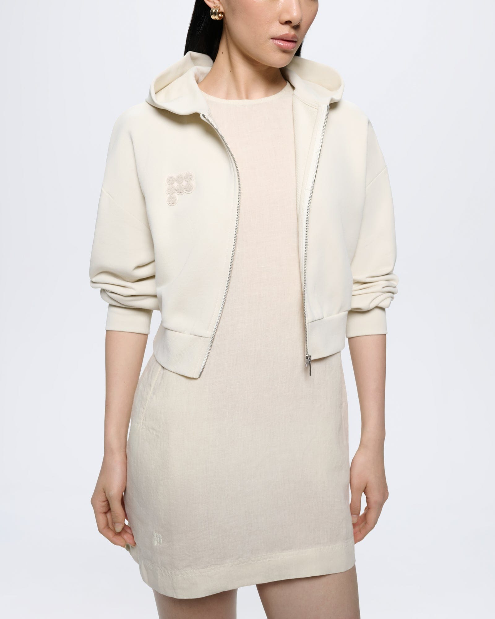 Womens Bone White organic cotton cropped zip hoodie with oversized fit, ribbed cuffs/hem, and tonal circular logo