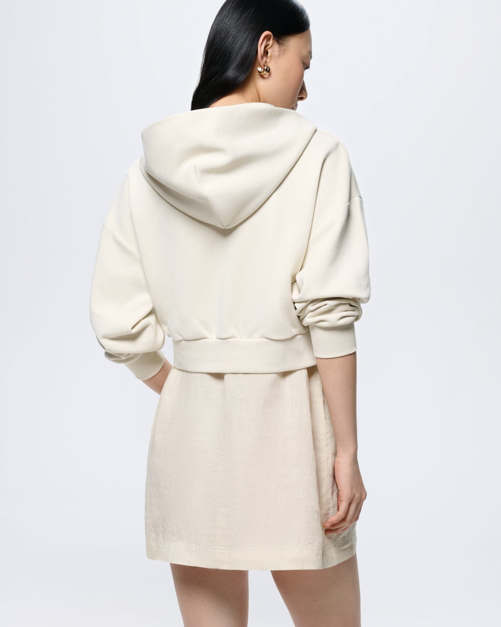 Womens Cropped Zip Up Hoodie in Bone White oversized fit 100% organic cotton with ribbed cuffs & hem Model back view