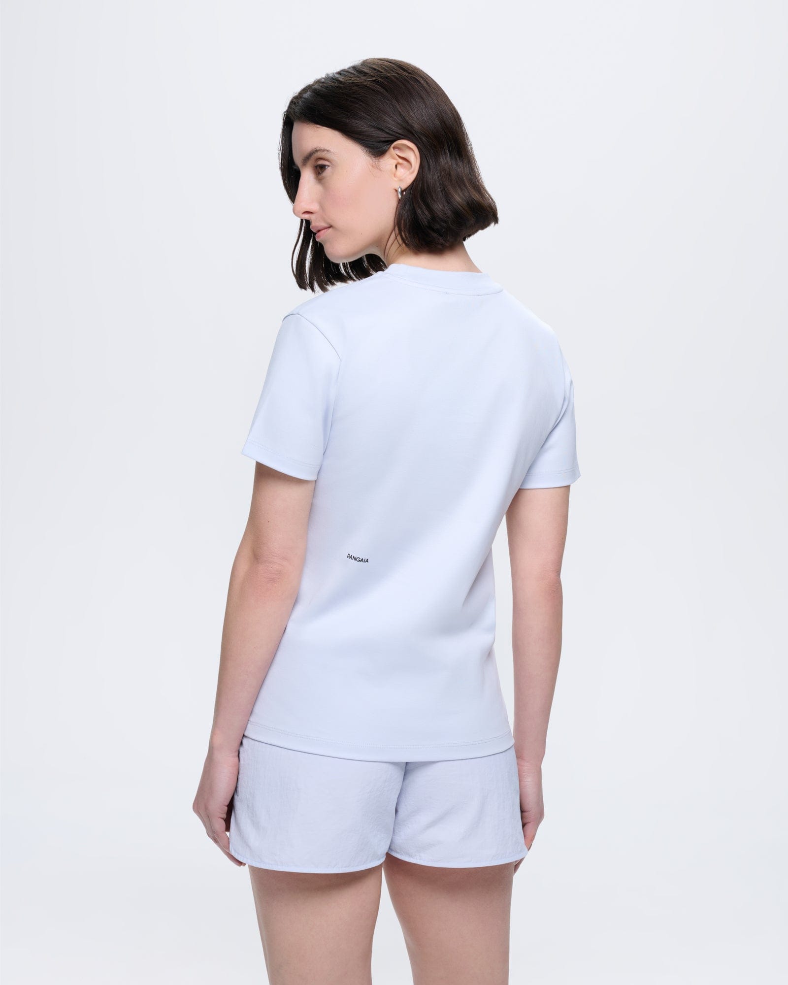 Womens Ice Grey Interlock T-Shirt, 100% organic cotton, regular fit, crew neck. Model from back, PANGAIA logo