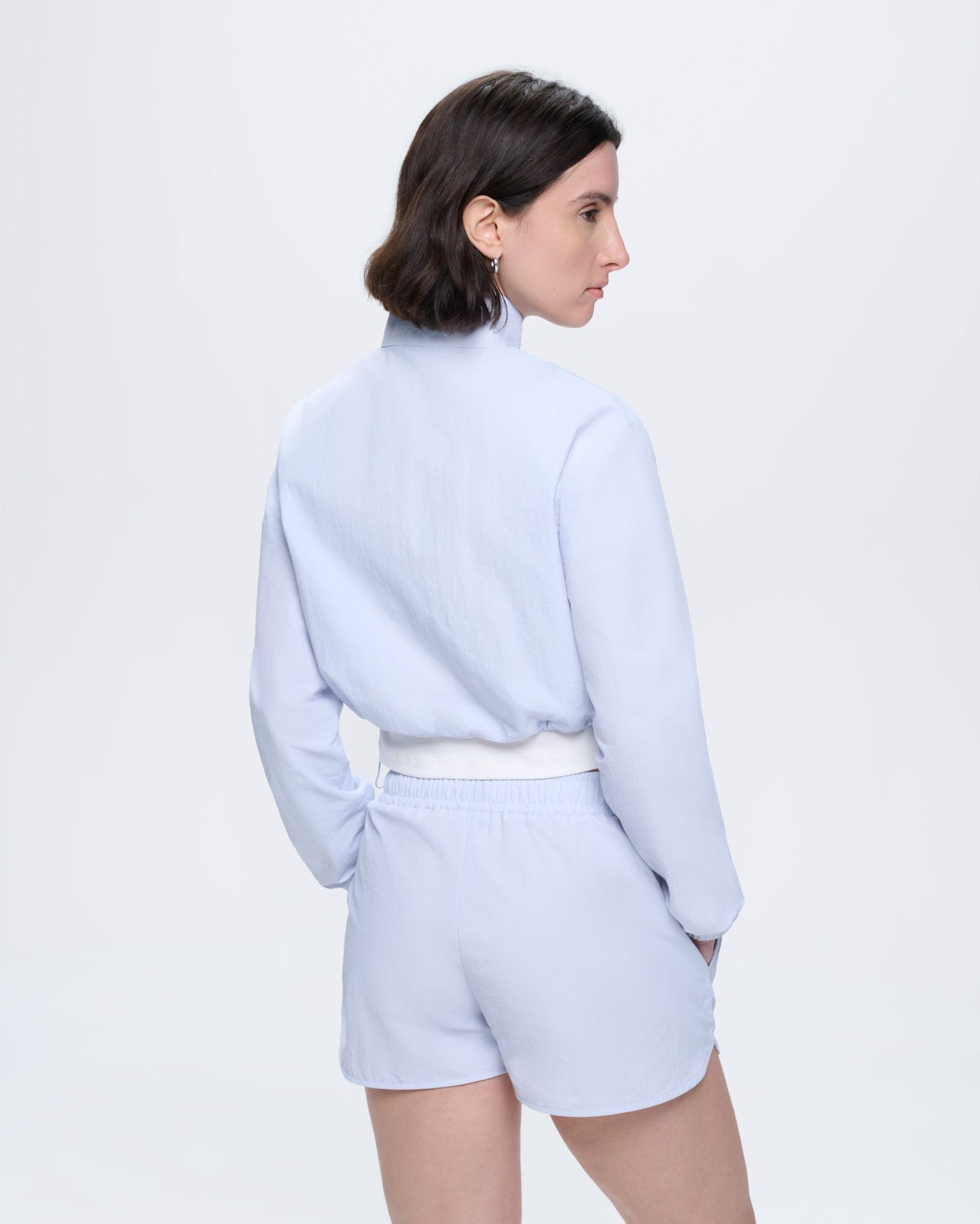 Womens Recycled Nylon Zip Up Jacket, Ice Grey, cropped. Model facing away, looking left. Lightweight polyamide fabric