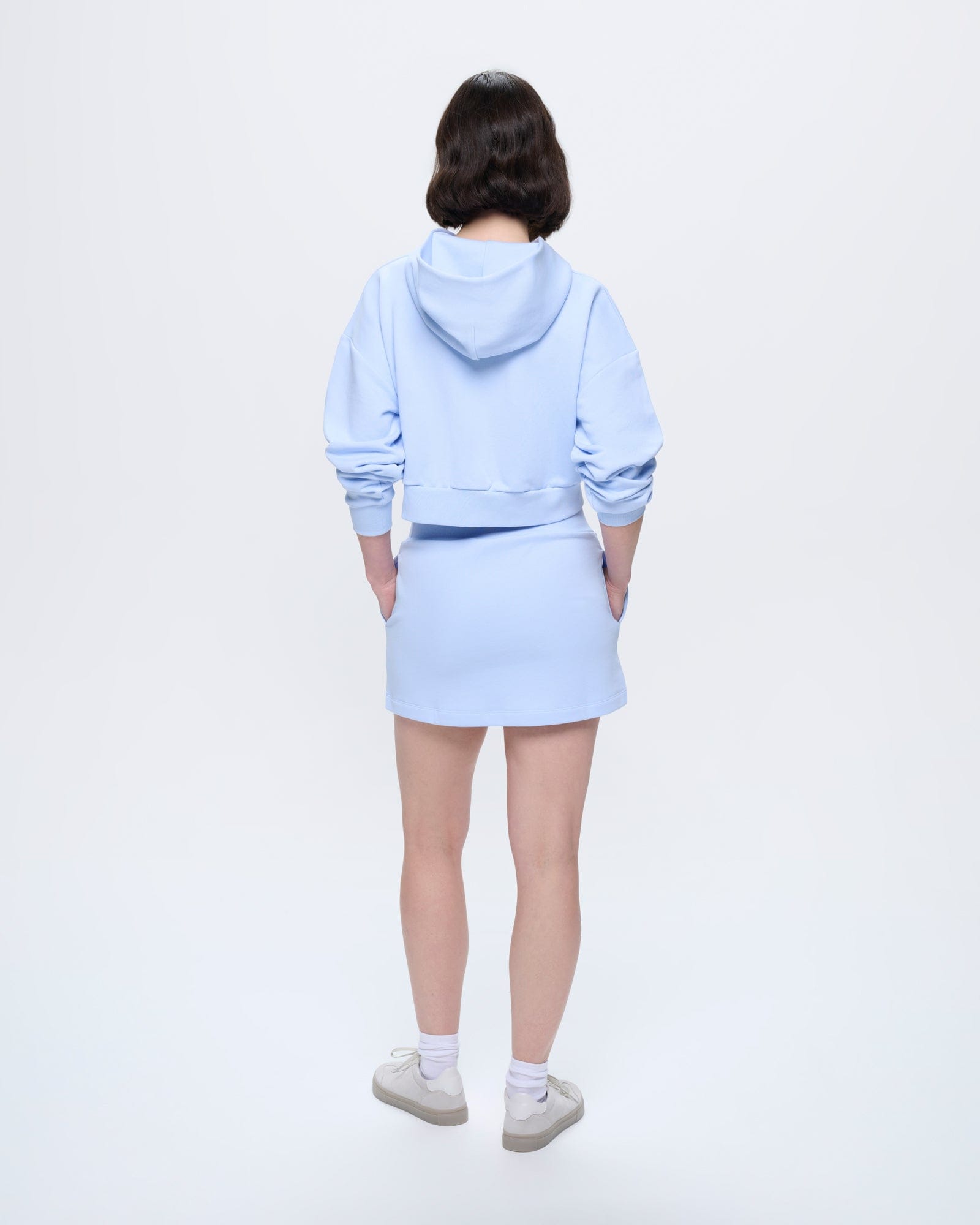 Womens Wildflower Blue organic cotton regular fit mini skirt, structured silhouette, side pockets, on model from back