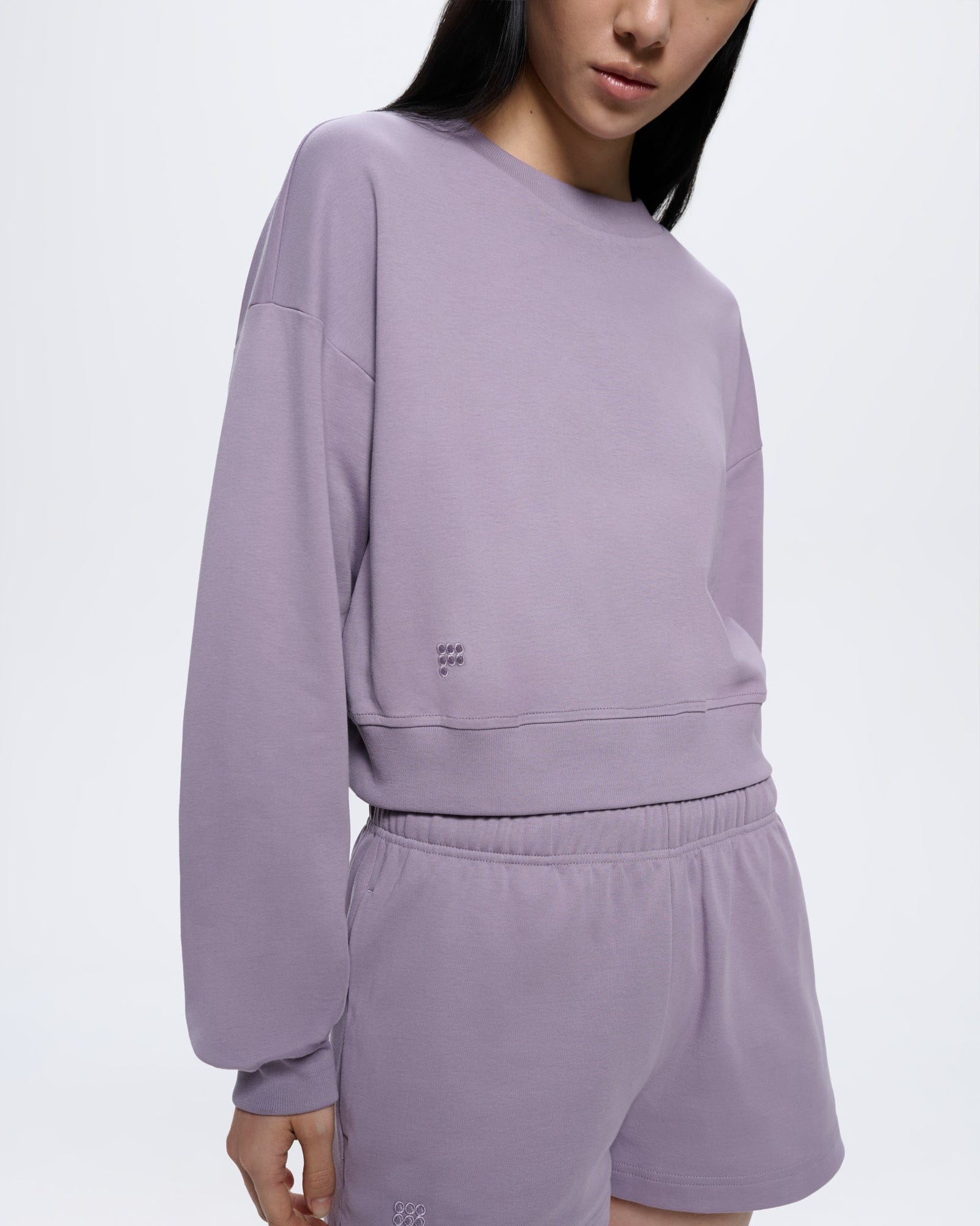 Womens Dusty Mauve organic cotton cropped sweatshirt. Crew neck, long sleeves, ribbed cuffs and hem, tonal embroidered logo