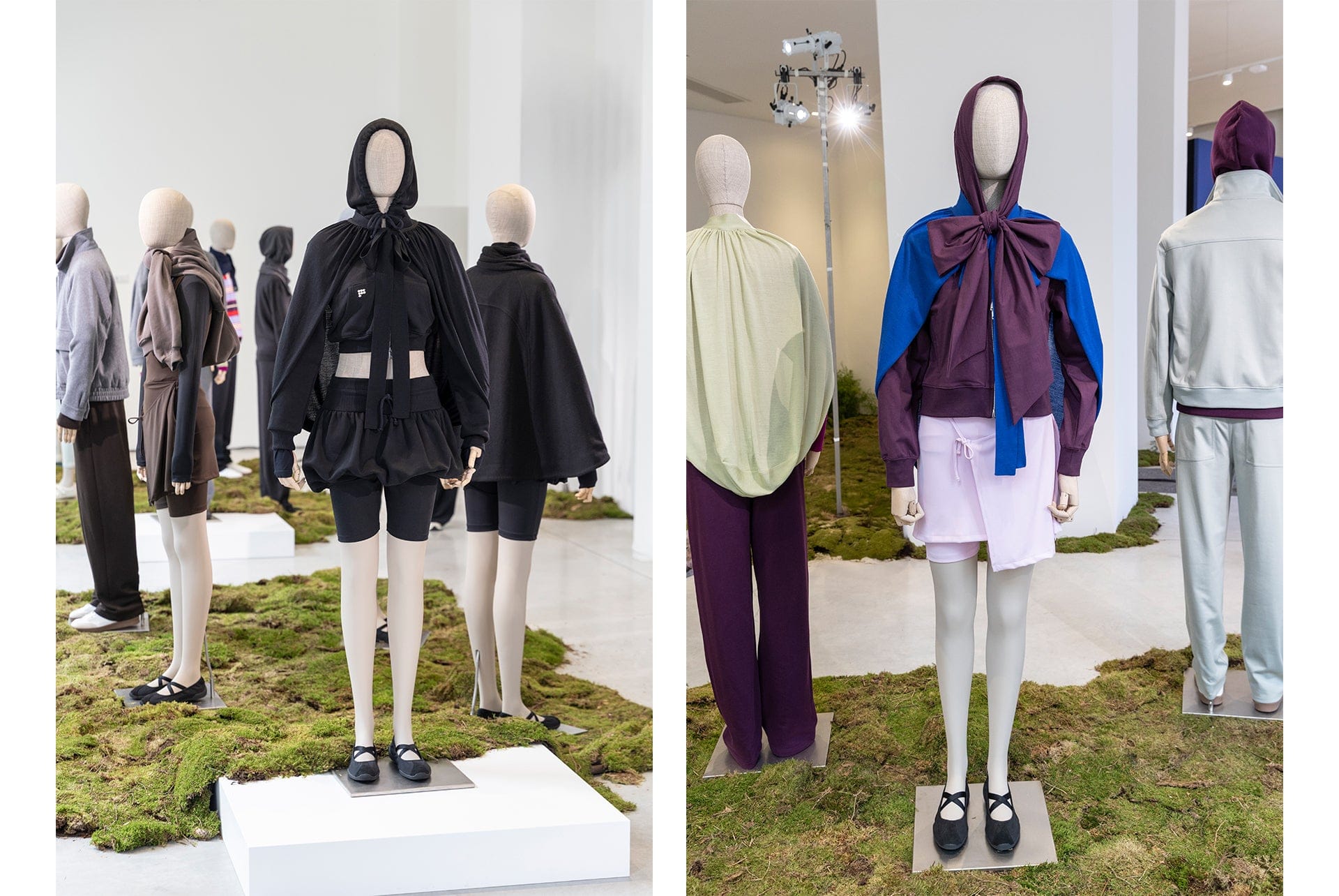 Black hooded cape with shorts, purple hooded jacket with blue bow, pink skirt on mannequins. Premium layered activewear