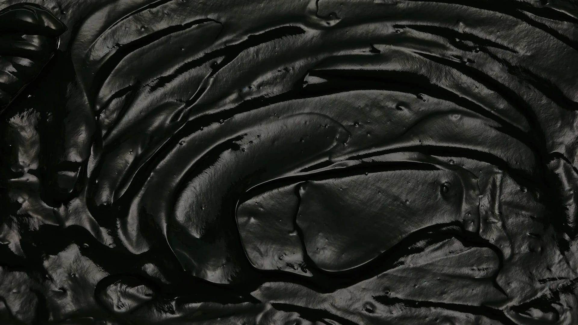 Deep black premium textured material, glossy finish, rich matte and lustrous flowing surface packshot