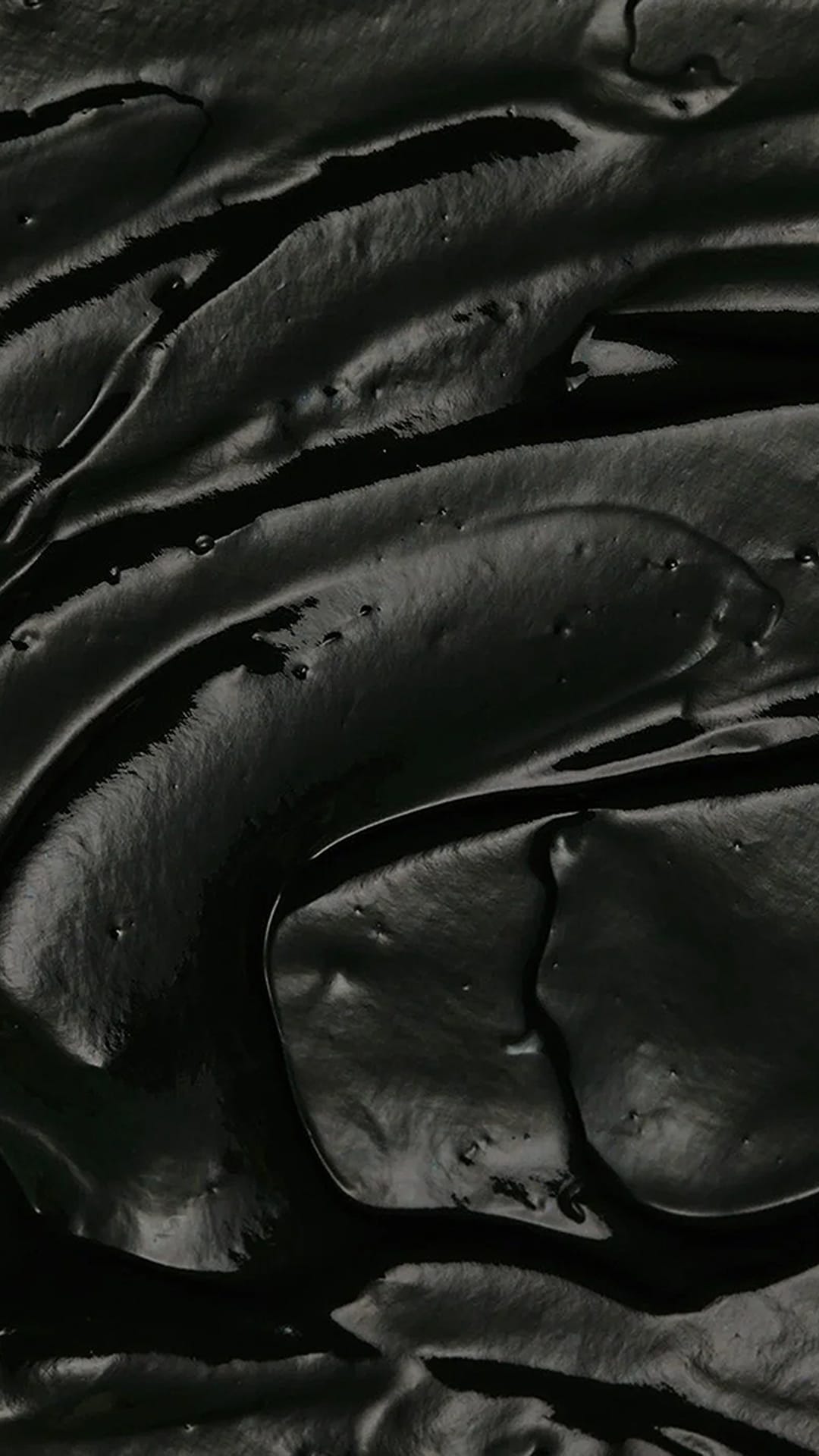 Luxurious deep black textured fabric swatch. Fluid, undulating ripples with subtle glossy and matte contrasts