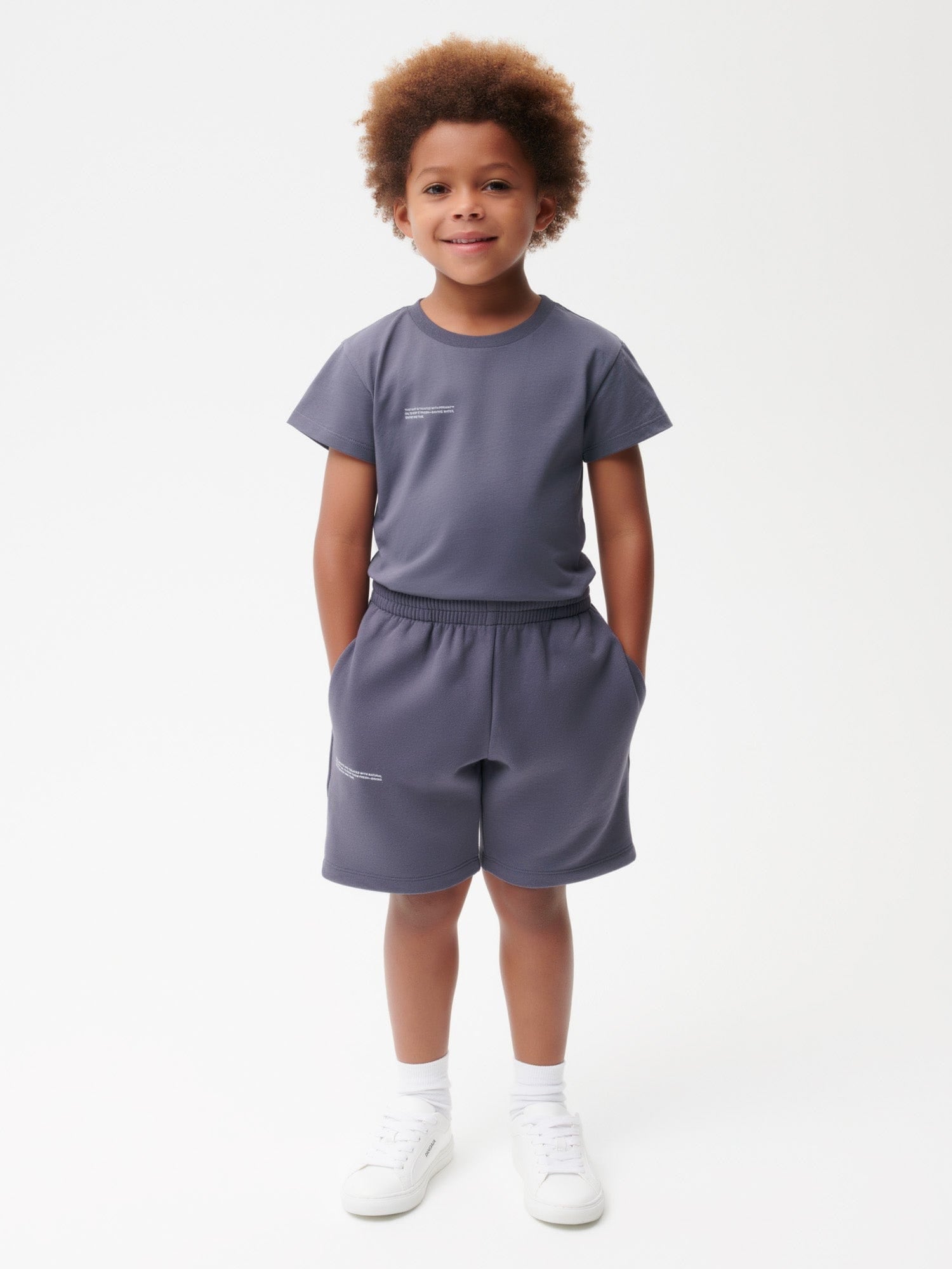 Young boy wearing Archive Kids' 365 Midweight Long Shorts in slate blue 100% organic cotton