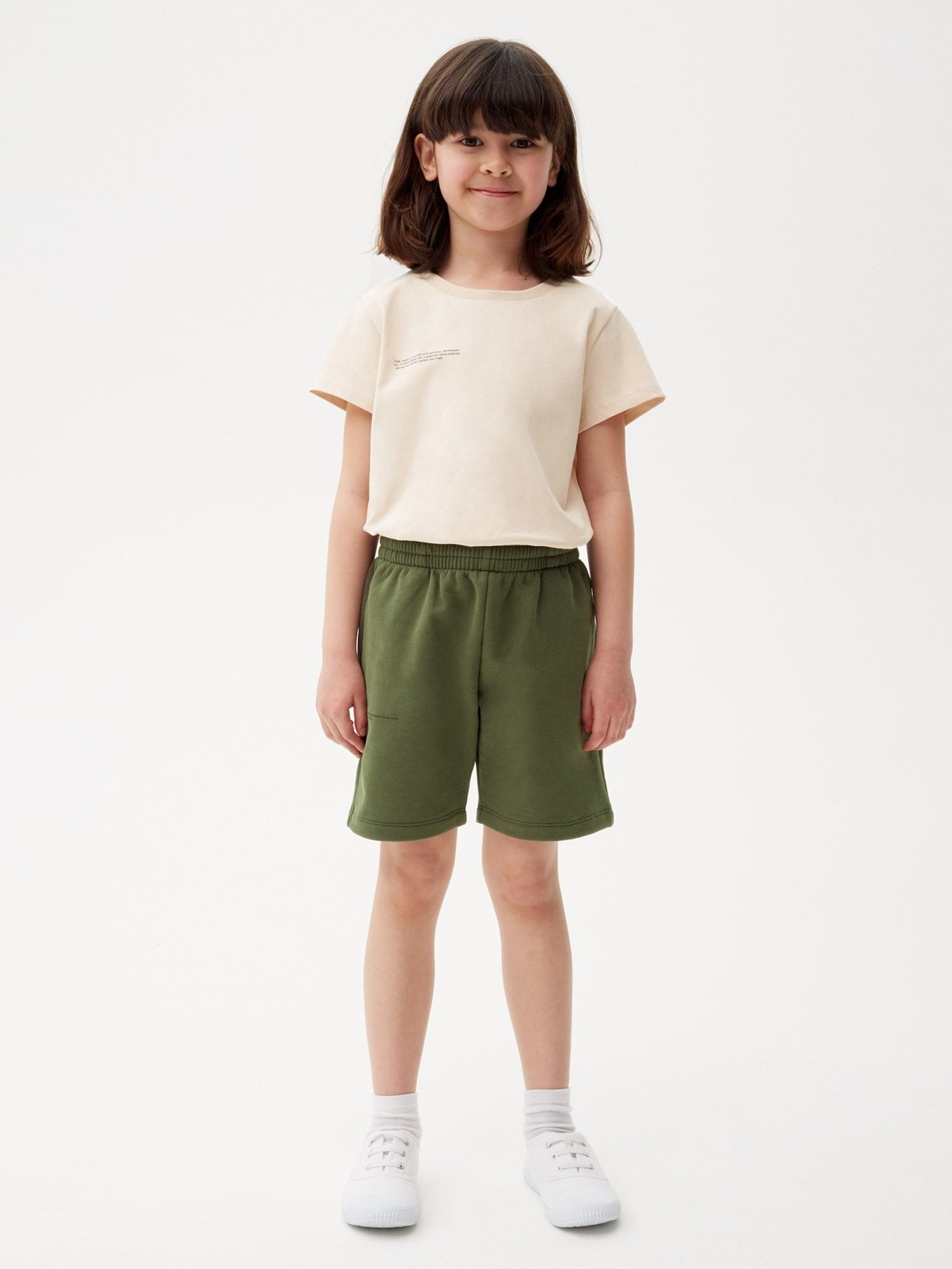 Kids' rosemary green organic cotton midweight long shorts with elasticated waist worn by child