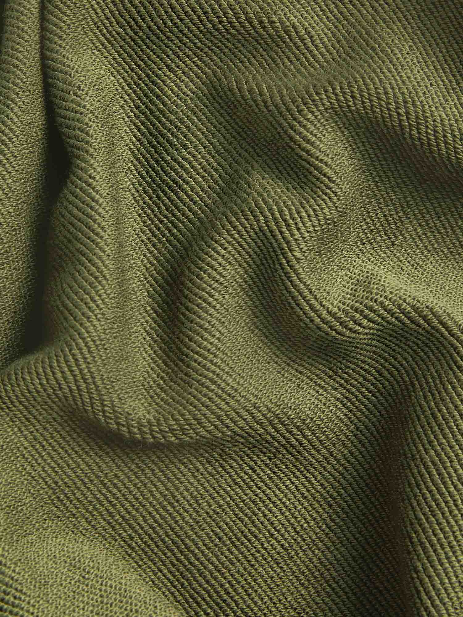 Archive Kids' 365 midweight long shorts in rosemary green. Close-up of organic cotton textured fabric